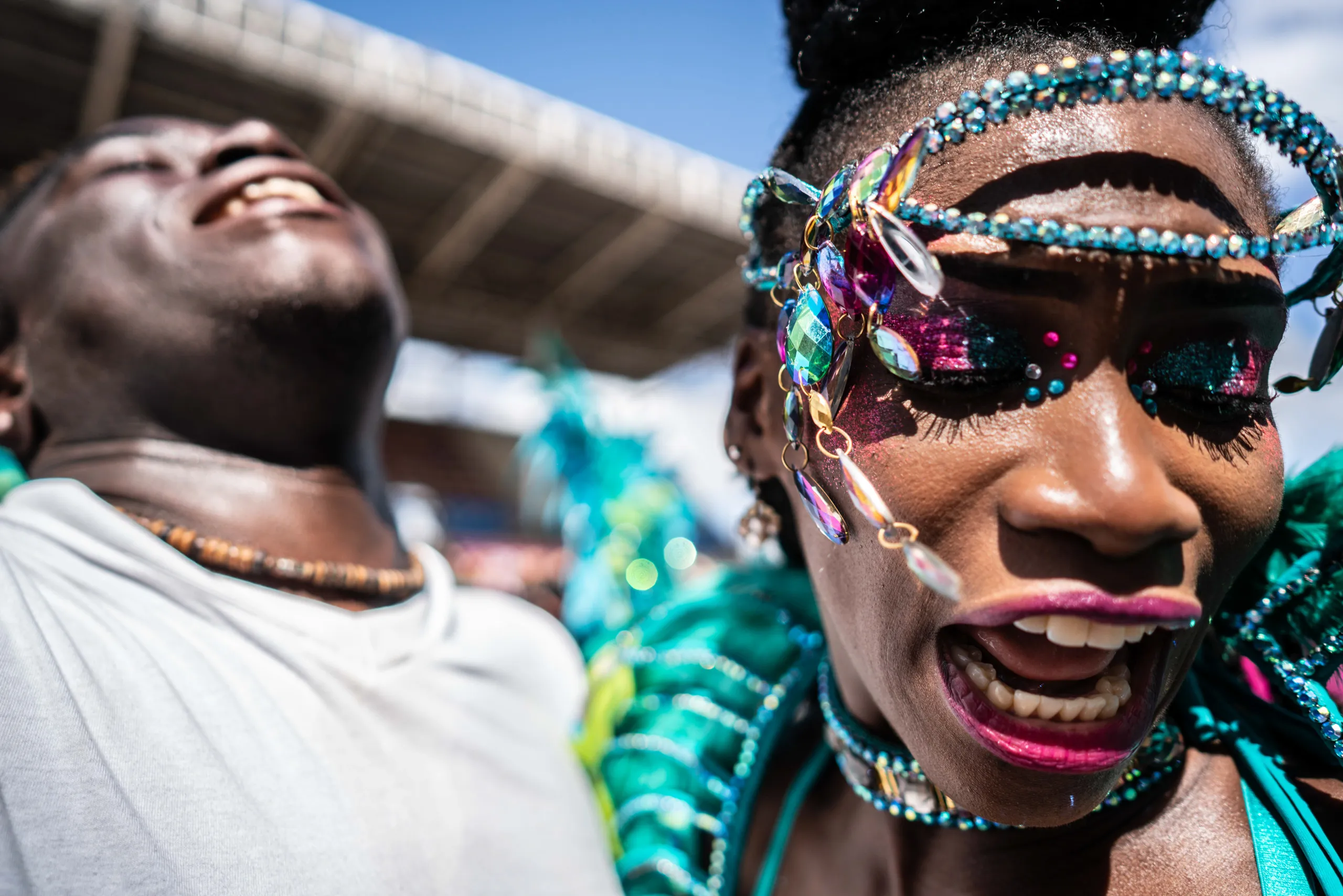 Two masqueraders laughing in the crowd
