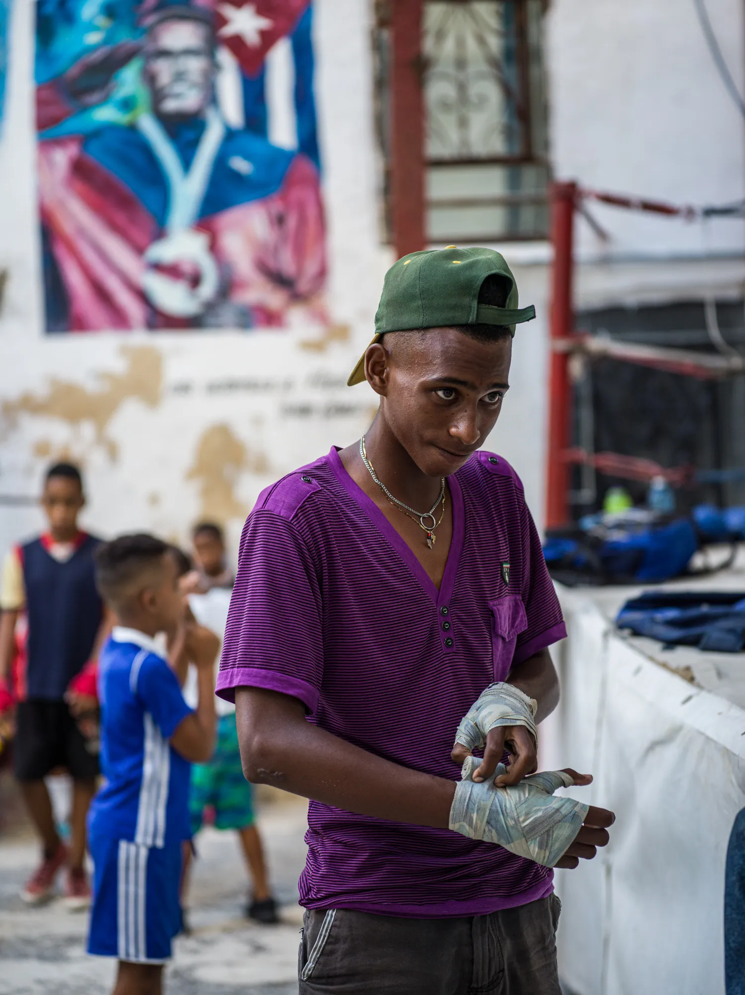A young boxer wrapping his hands