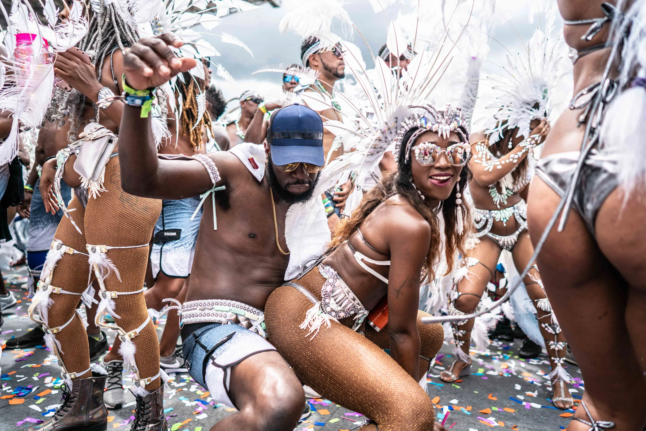 Masqueraders dancing on the road in confetti