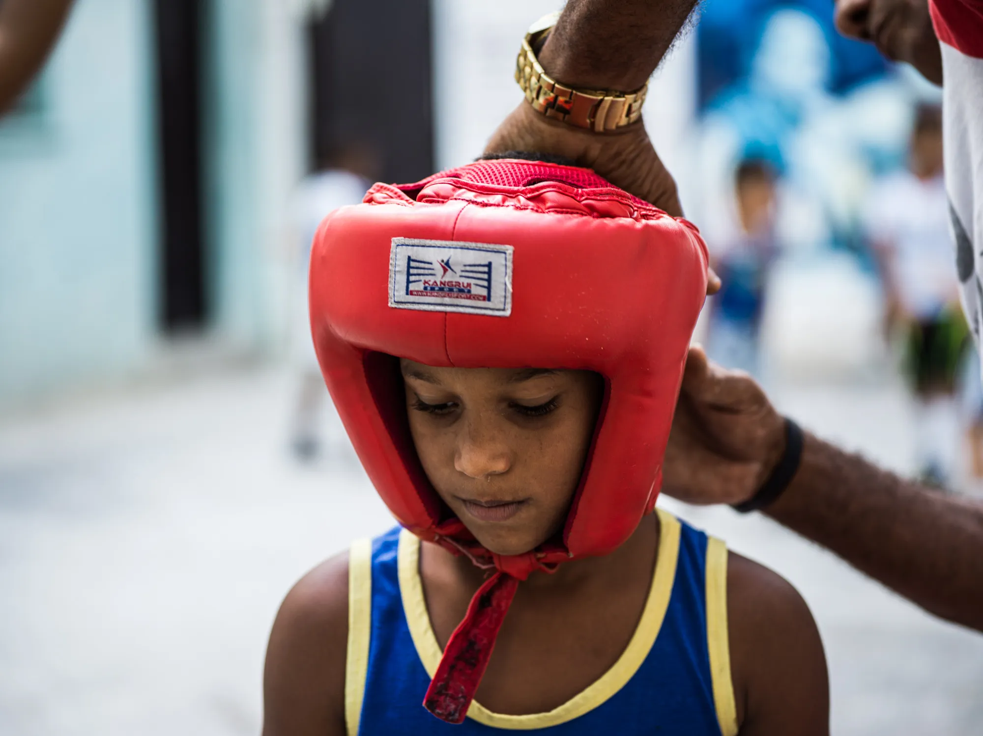 A coach adjusting a headguard