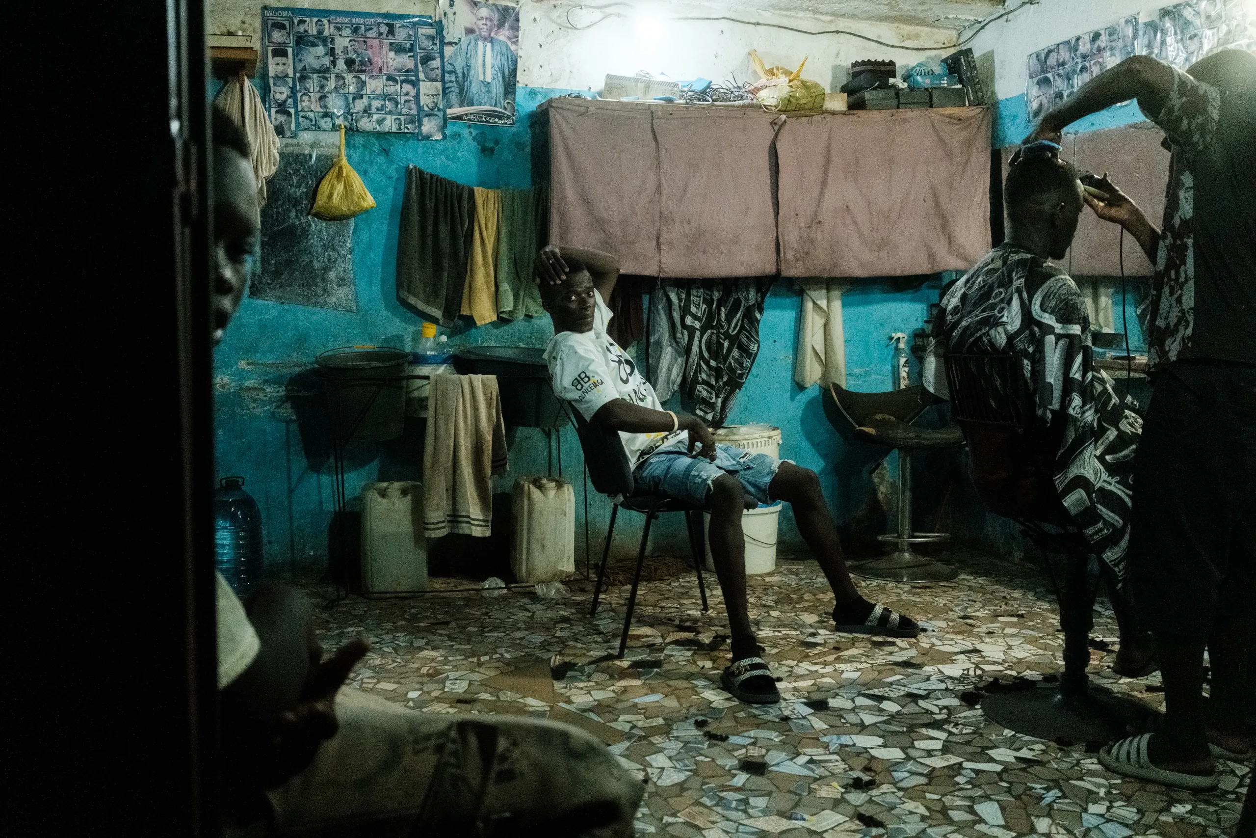 A man sitting in a hair salon at night