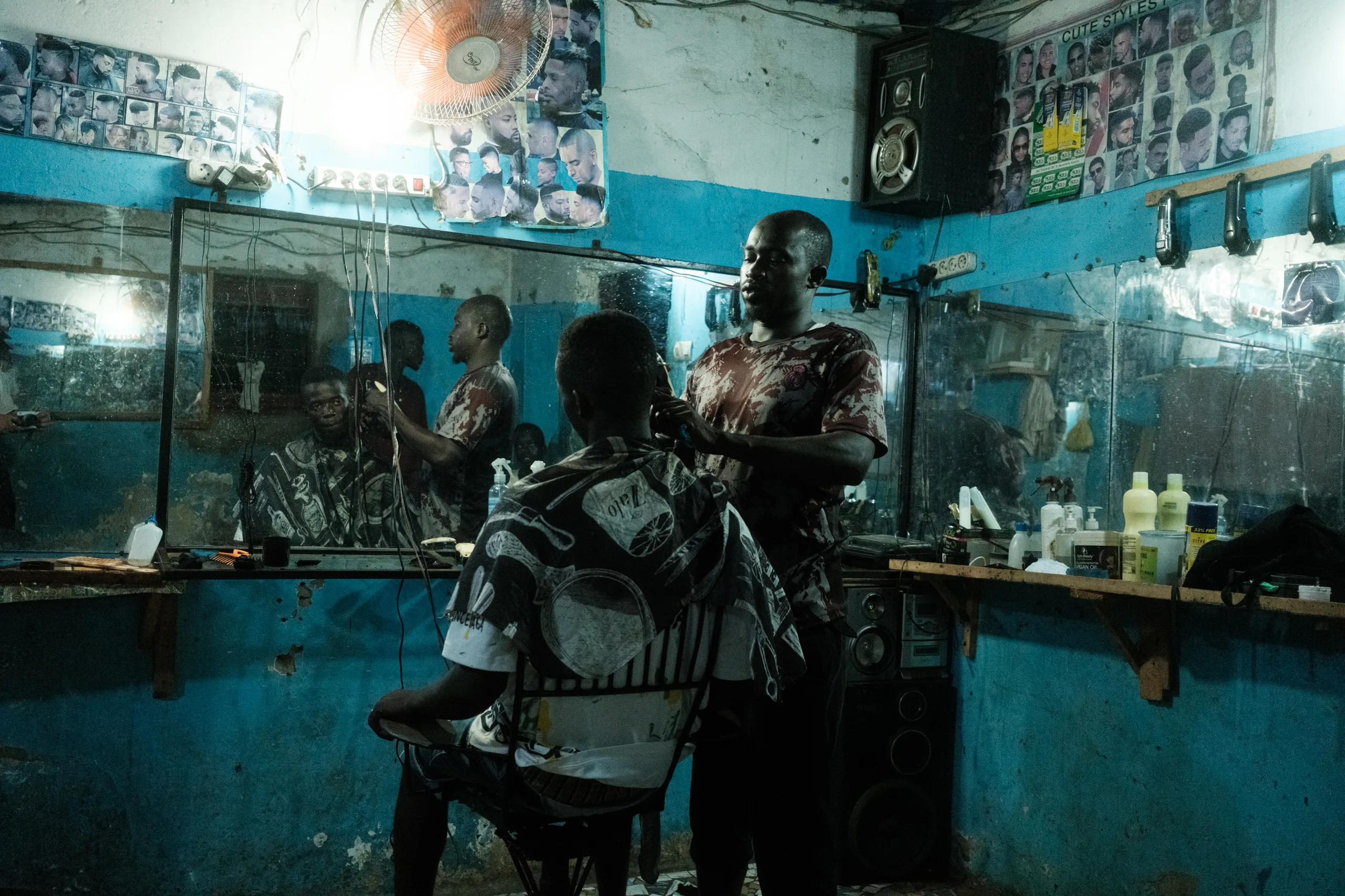 A man sitting in a barbershop in the city
