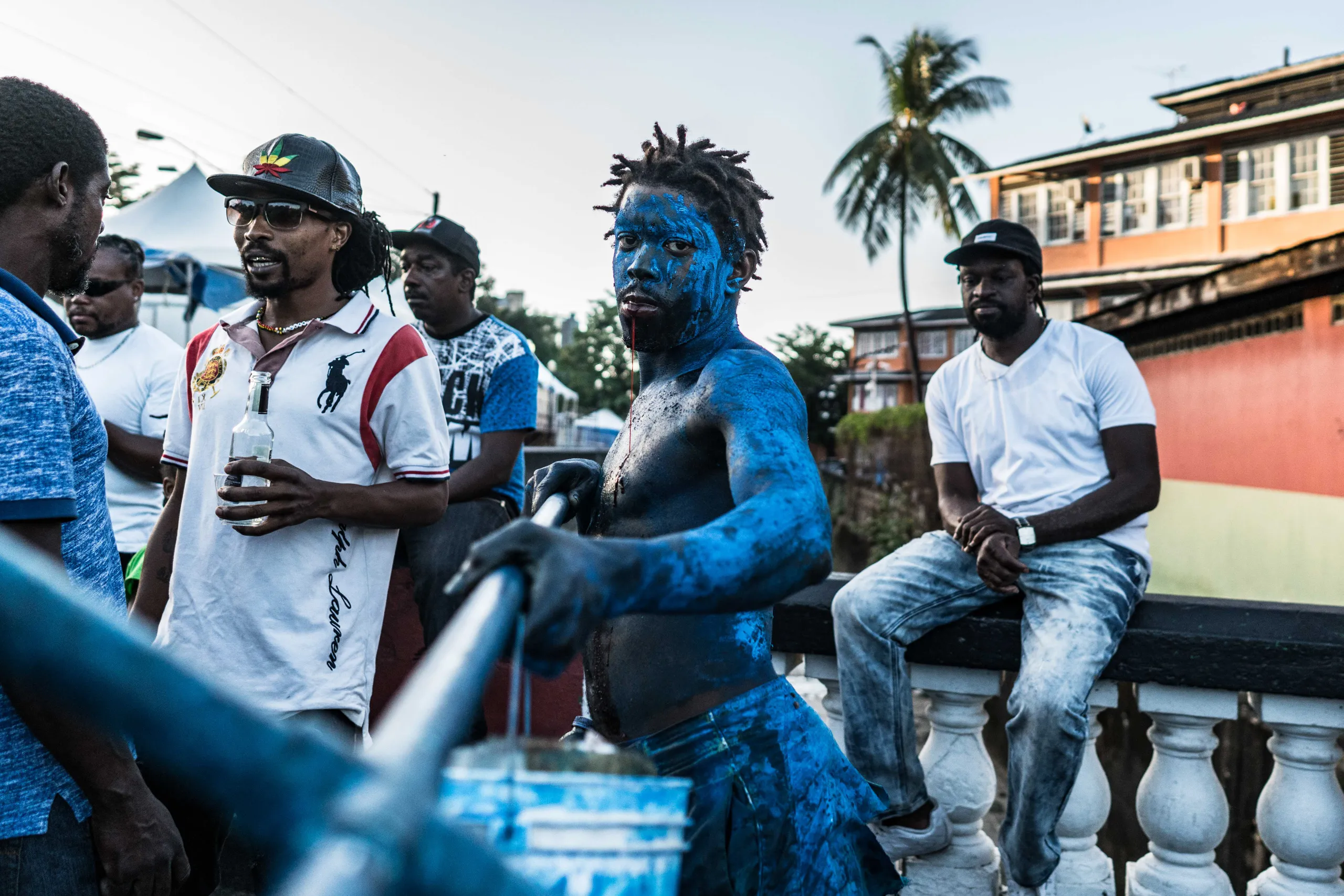 A man in blue paint among the crowd at J'Ouvert