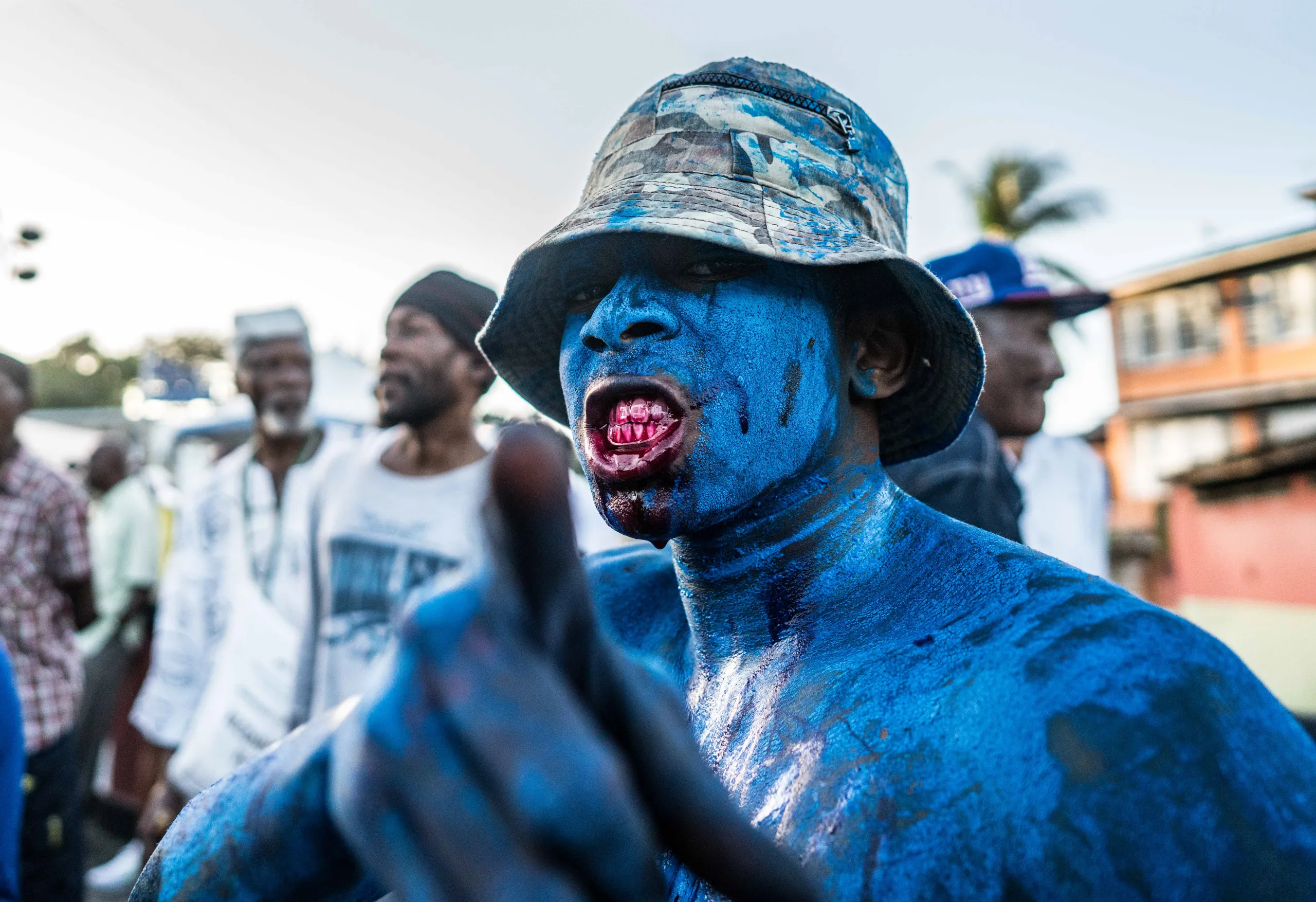 A man covered in blue paint on J'Ouvert morning